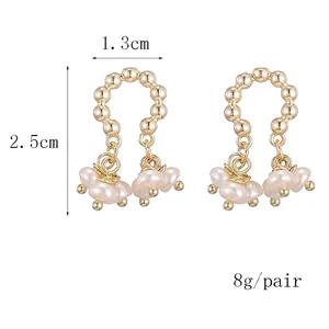 U-shaped gold pearl earrings with baroque freshwater pearls in a minimalist design