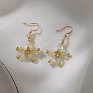 Elegant star-shaped drop earrings with iridescent crystal beads and gold hooks
