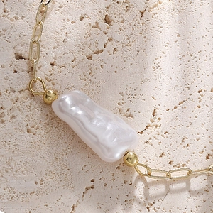 French style 14K gold plated bracelet featuring unique baroque pearl and oval link chain