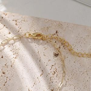 Detailed view of 14K gold plated baroque pearl bracelet with adjustable paperclip chain