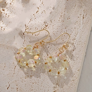 Elegant gold drop earrings featuring circular faceted clear crystal beads with AB coating