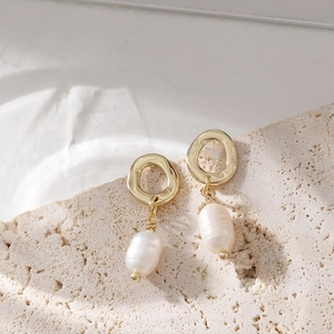 Minimalist S925 silver baroque pearl drop earrings in gold on stone background