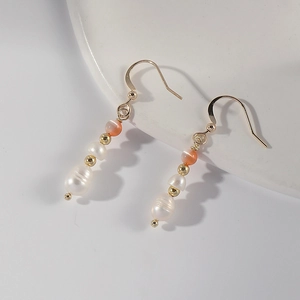 Detail of 14k gold-plated drop earrings featuring natural stones and freshwater pearls