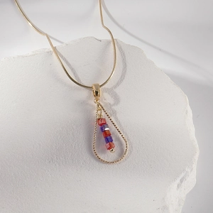 Minimalist gold snake chain necklace with a water drop pendant and colorful crystals