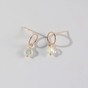 Gold-plated 14K hoop earrings with pink crystal heart pendant on plain grey background