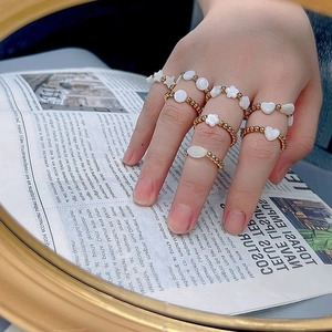 18K gold plated stainless steel beaded rings with natural shell charms worn on hand
