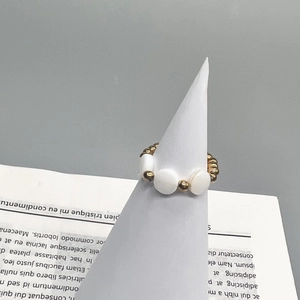 Detail of 18K gold stainless steel beaded ring with natural white shell beads