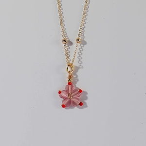 Detail of pink flower pendant with gold beads on a tarnish-free stainless steel chain