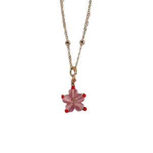 Pink peach blossom pendant necklace in gold titanium steel on a clean white background