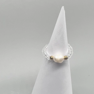 Detail of freshwater pearl ring with golden beads and transparent faceted crystals