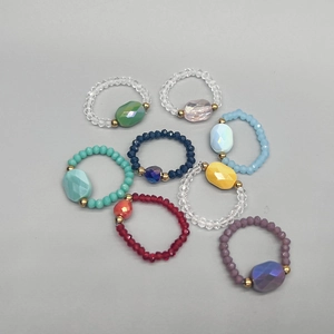 Colorful faceted crystal elastic rings set with large oval center stones and gold beads