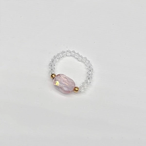 Detail of pink oval stone and faceted crystal beads on a handmade stretch ring