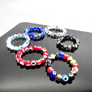 Elastic beaded evil eye rings in assorted colors with polished gold or silver metallic accent