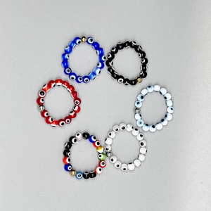 Set of 6 Evil Eye elastic beaded rings in assorted colors with metallic accent beads