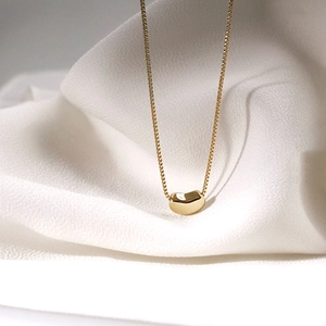Elegant gold bean pendant necklace with polished mirror finish on box chain jewelry