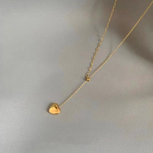 Minimalist 18K gold heart pendant necklace with thin O-chain and polished mirror finish