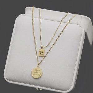 Double-layered 18K gold plated titanium necklace with Good Luck and Paris pendants