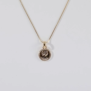 Macro view of French vintage coin pendant and flat snake chain necklace in 18K gold finish