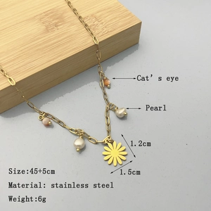 Gold stainless steel necklace featuring cat's eye stone, pearl, and yellow daisy pendant