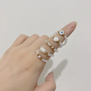 Beaded stacking rings set with evil eye charm and freshwater pearl for women