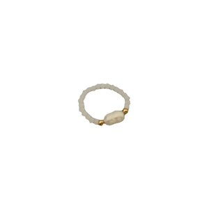 Handmade beaded ring with white pearls and gold metal beads on a clean white background