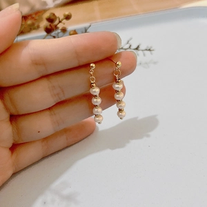 Elegant gold-tone long fringe drop earrings with five round white freshwater pearls