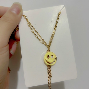 18K gold plated titanium steel necklace with a smile face pendant and tassel chain