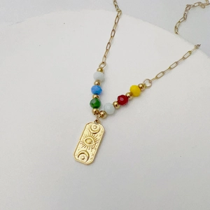 Detail of 18K gold plated evil eye pendant with sun moon stars and colorful beads