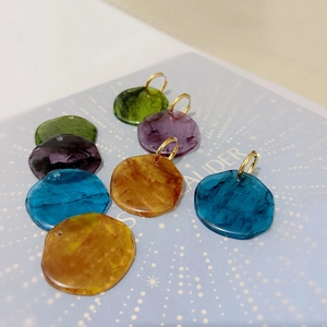 French vintage style acetate resin disc earrings with gold accents and marble texture