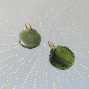 Macro view of French vintage green resin disk earrings with golden titanium steel clasps