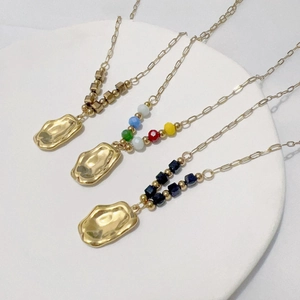 Luxury gold necklaces with textured pebble pendants and colorful beaded chain accents