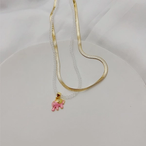 Gold snake chain and beaded necklace set featuring a pink enamel elephant pendant