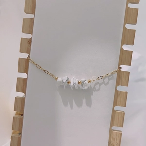 Bohemian gold chain bracelet featuring natural white stones and tiger eye beads