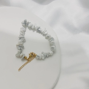 Detail of irregular white turquoise beads with 18K gold plated lobster clasp chain