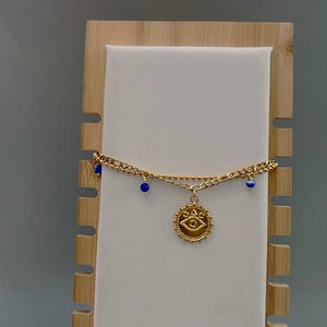 Double-layered evil eye bracelet in 18K gold finish with blue beads and coin pendant