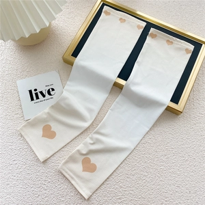 Close-up of cream ice silk sun sleeves with khaki heart patterns on breathable fabric