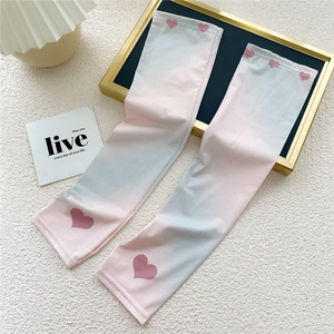 Close-up of gradient pink and blue cooling arm sleeves with heart pattern detail