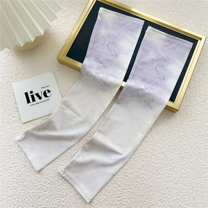 Detail of lavender gradient cooling arm sleeves on a minimalist aesthetic display tray