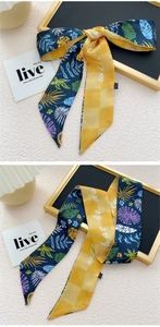 Détail d'un foulard en soie double face avec imprimé tropical et motifs à carreaux jaunes