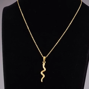 French vintage gold snake pendant necklace with detailed scale texture on a black bust display