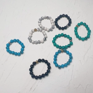 Set of 7 elastic beaded rings with turquoise stones and stainless steel accents