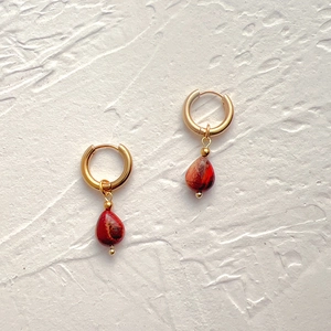 Macro detail of tear-drop agate stone earrings with 18k gold plated stainless steel hoops