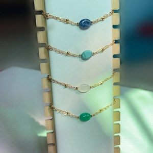 French vintage double-layered gold bracelet with colorful natural stones on wooden stand