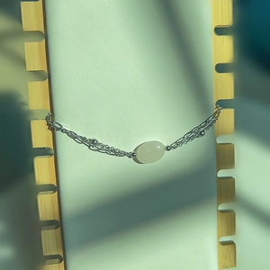 Macro shot of double-layer chain bracelet featuring a translucent oval natural stone