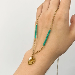 18K gold plated necklace with green beads and monstera leaf pearl pendant on model