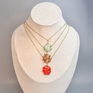 Bohemian gold chain necklaces with irregular glass pendants in green, amber, and red