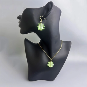 Bohemian gold chain necklace with light green irregular glass pendant on model