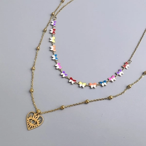 Detail of double-layer gold necklace with colorful enamel butterflies and evil eye pendant