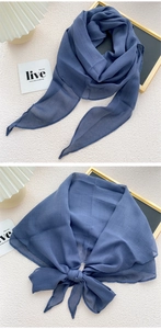 Detail of Morandi blue sheer silk scarf showing texture and elegant bow knot styling