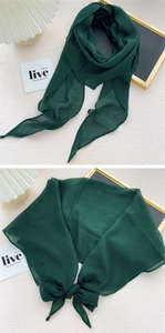 Detail of dark green lightweight scarf showing fine texture and versatile bow styling